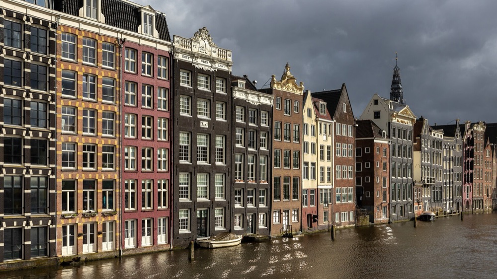 Colourful canal houses on the Damrak in Amsterdam