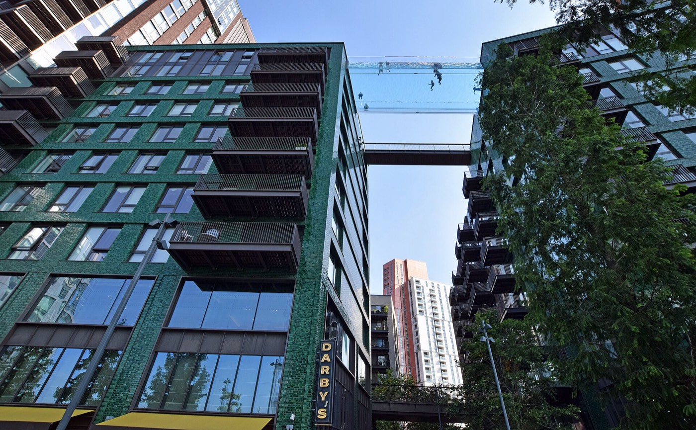 Modern apartment buildings with balconies and the glass Sky Pool at Embassy Gardens, London